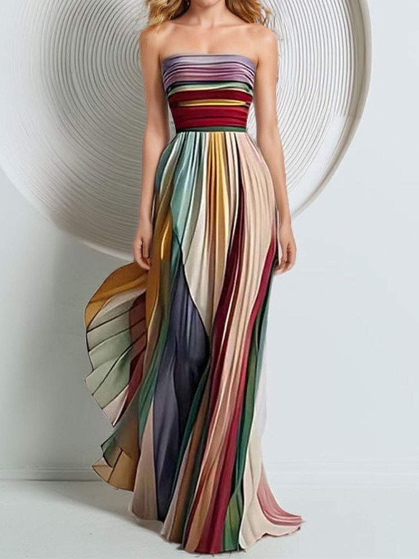 Strapless pleated maxi dress with colorful stripes and a dramatic silhouette.