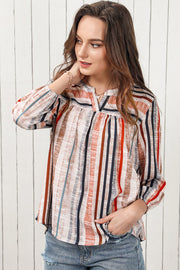 Vertical stripe gathered yoke blouse with v-neck and long sleeves.