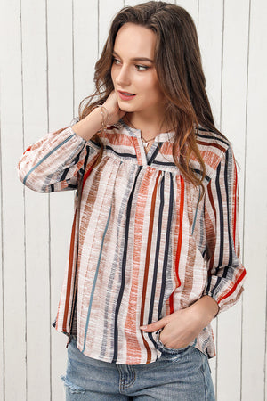 Vertical stripe gathered yoke blouse with v-neck and long sleeves.