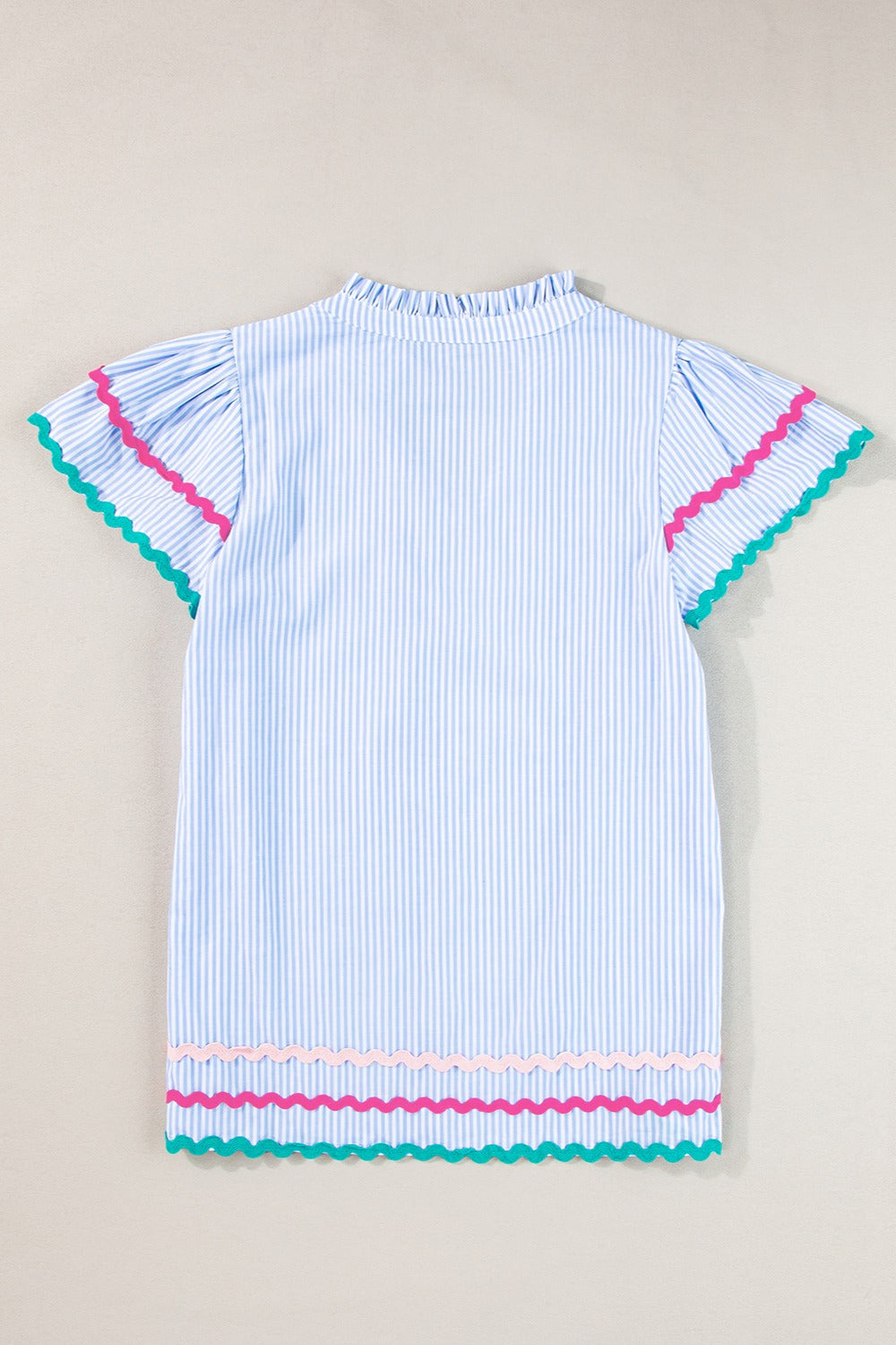 Light blue striped blouse with ruffled neckline, flutter sleeves, and scalloped trim in pink and teal.
