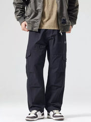 Black oversized cargo pants with multiple pockets and adjustable drawstring waist.