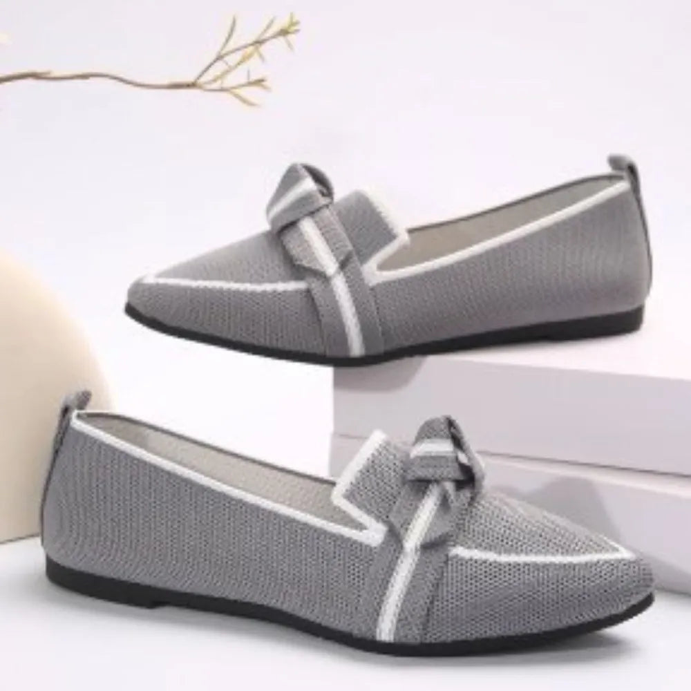 Light Gray knit bow loafers with pointed toe and white trim.