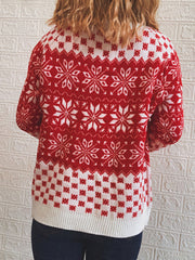 Red and white acrylic knit sweater with snowflake pattern and ribbed hem.
