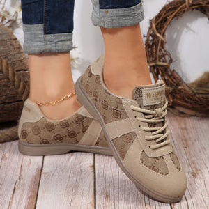 Chic lace-up sneakers in beige with monogram pattern and suede accents.