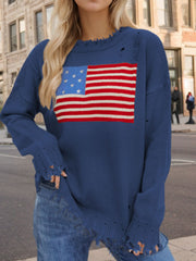 French blue knit sweater with frayed details and an American flag graphic.
