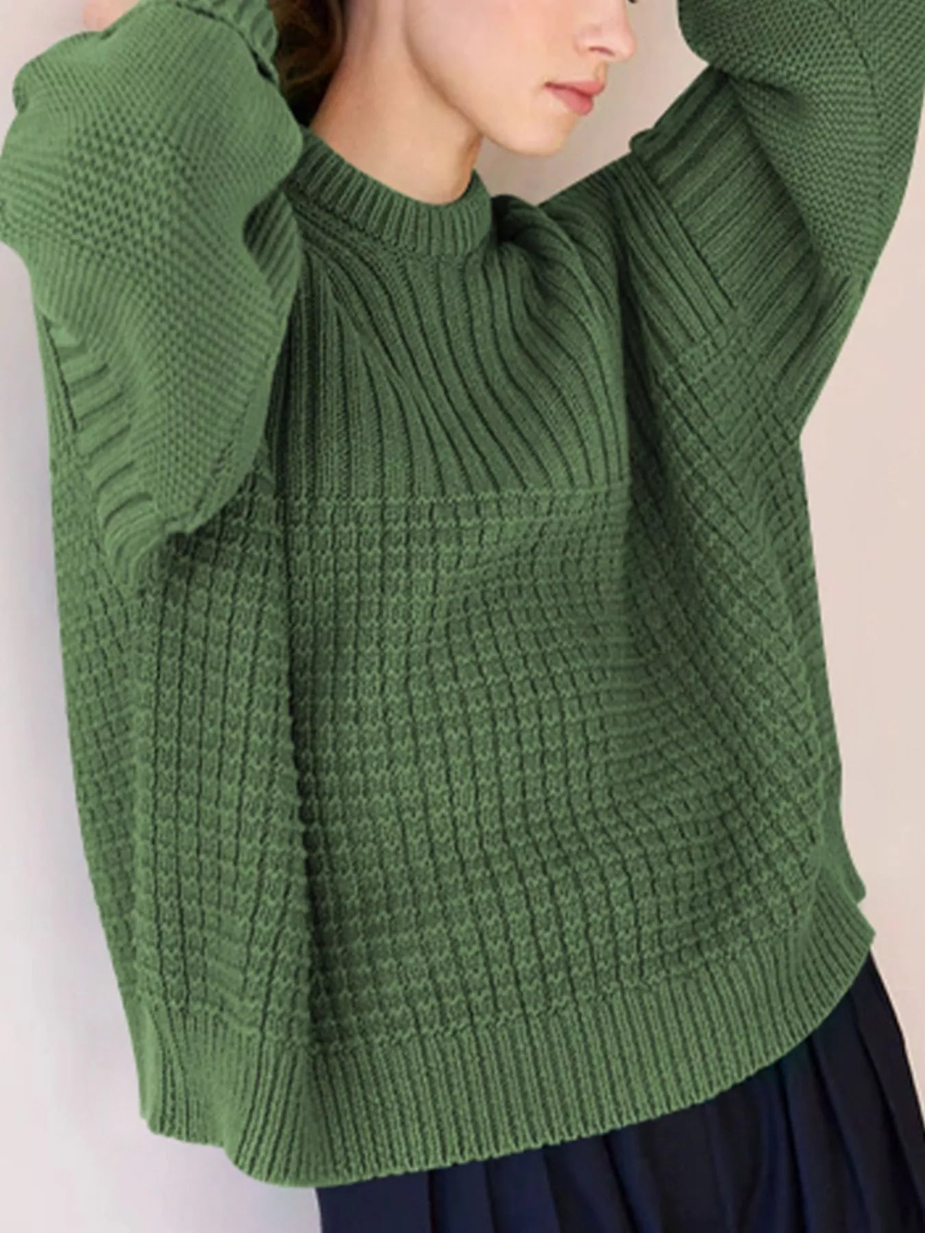 Moss green textured knit round-neck pullover sweater with mixed stitch patterns.