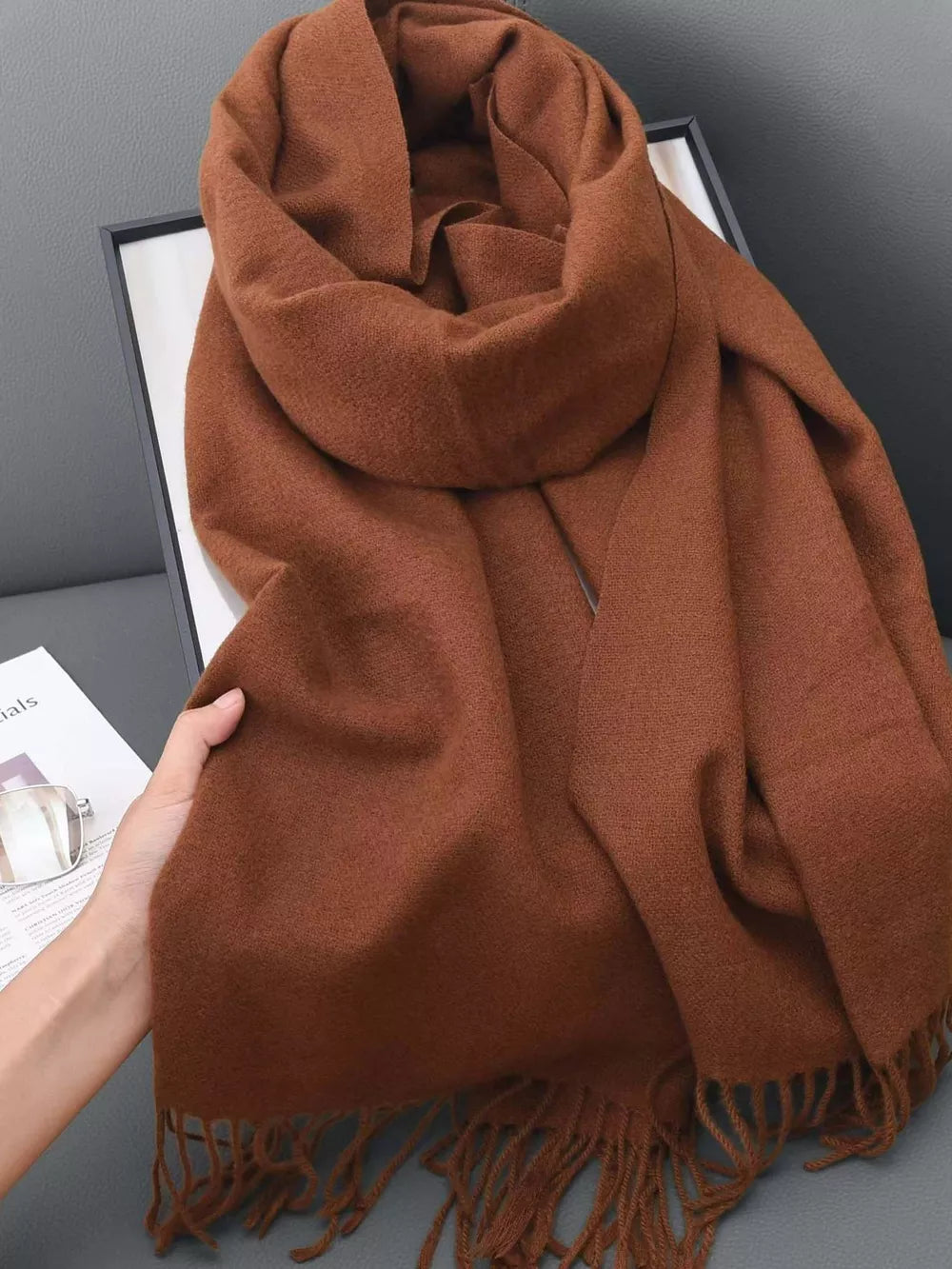 Coffee brown scarf with fringe detail and soft texture.