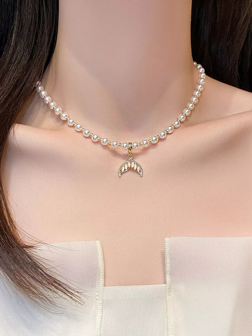 Mermaid tail pendant choker necklace with faux pearls and delicate gold chain.