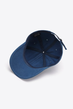 Navy baseball cap with adjustable strap and interior label.