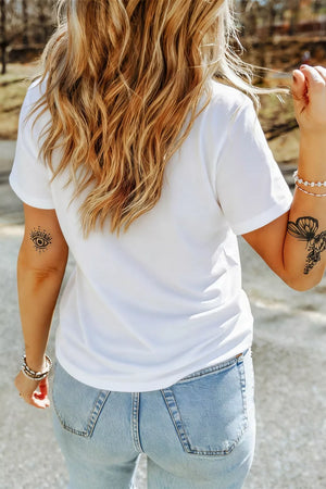 White polyester t-shirt with short sleeves and a pocket, styled with light wash jeans.