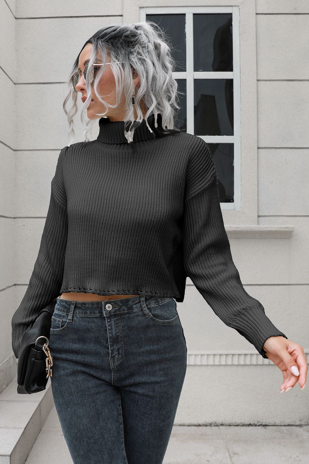 Black ribbed turtleneck sweater with scalloped hem detail