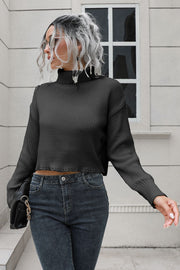 Black ribbed turtleneck sweater with scalloped hem detail