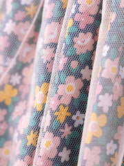 Children's floral tulle dress with pink, yellow, and white flowers on a charcoal background.