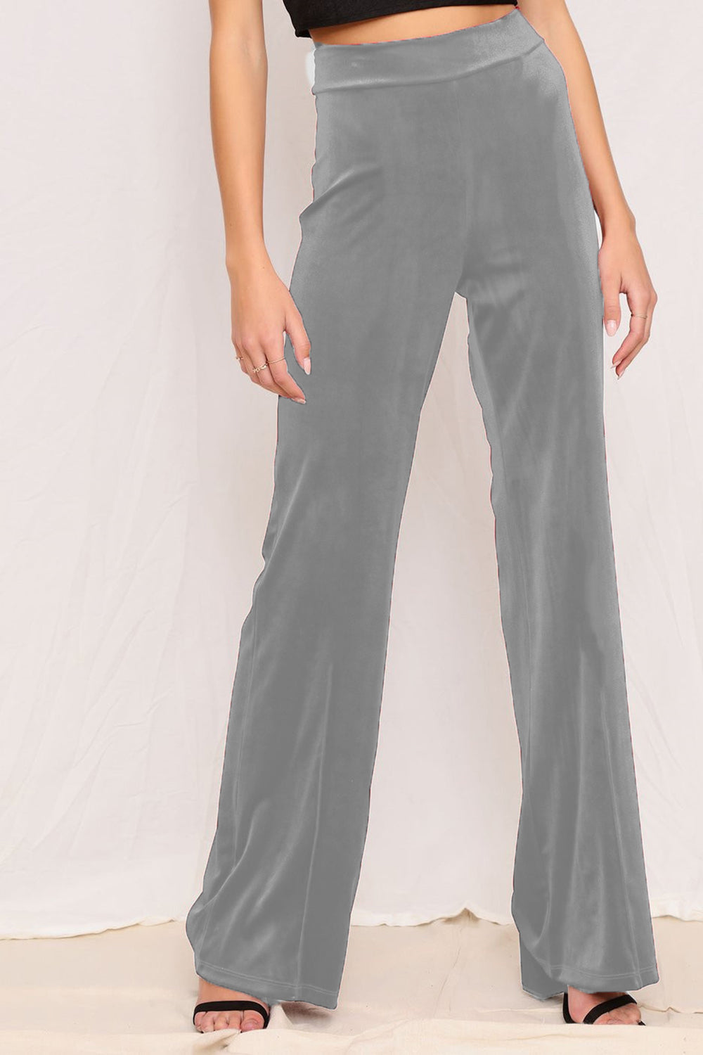 Plush velvet wide-leg trousers in gray, with a high waist and flowing silhouette.