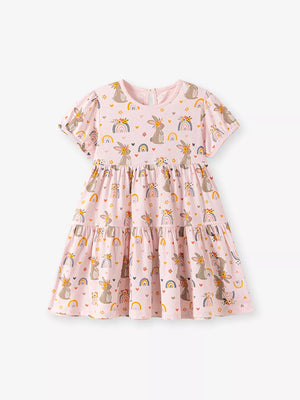 Pink cotton tiered dress with playful bunny and rainbow print, short sleeves, above knee length.