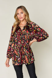 Silk tie-neck blouse with abstract print and button closure