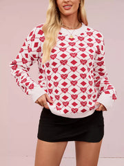 Red and white argyle heart knit sweater with crew neck and long sleeves.