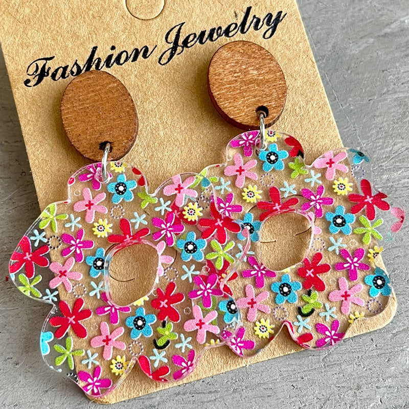 Floral acrylic bloom earrings with wood tops, featuring a colorful floral pattern.
