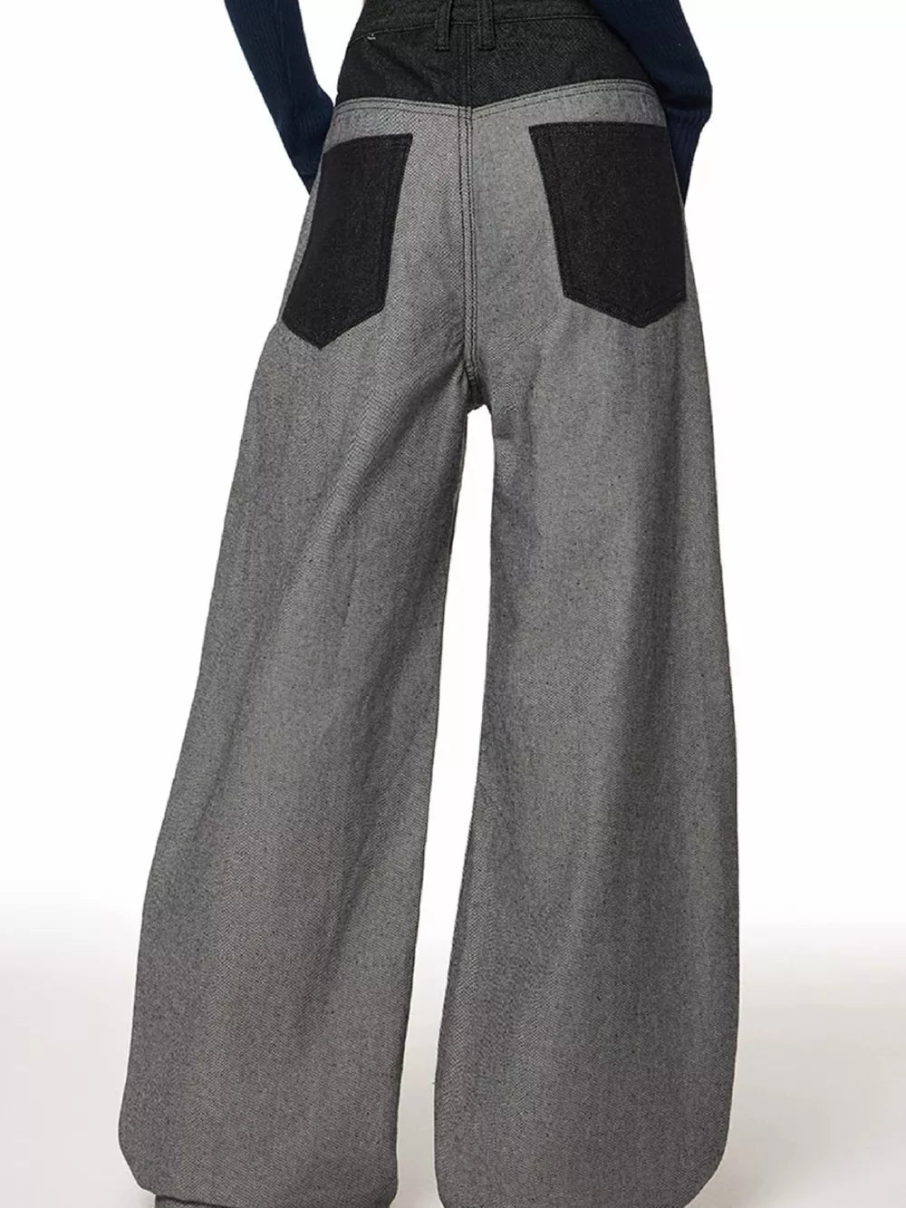 Men's grey wide leg jeans with dark grey back pockets and waistband.