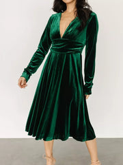 Dark green velvet midi dress with V-neck, long sleeves, and a-line skirt.
