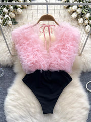 Pink ruffled V-neck bodysuit with black bottom and lace detail
