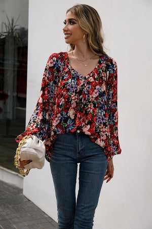 Red floral print blouse with gathered yoke and balloon sleeves.