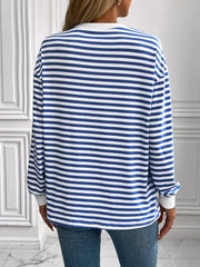 Crewneck sweatshirt with horizontal royal blue and white stripes, long sleeves, and white cuffs.