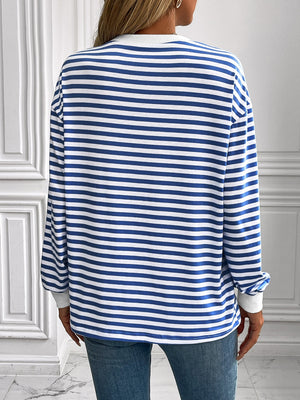 Crewneck sweatshirt with horizontal royal blue and white stripes, long sleeves, and white cuffs.