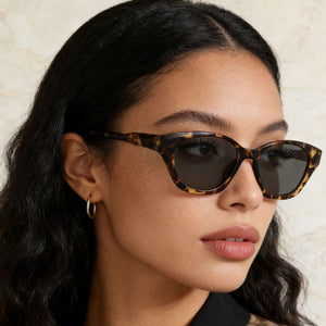 Uv400 acetate cat-eye sunglasses in leopard print with dark lenses.