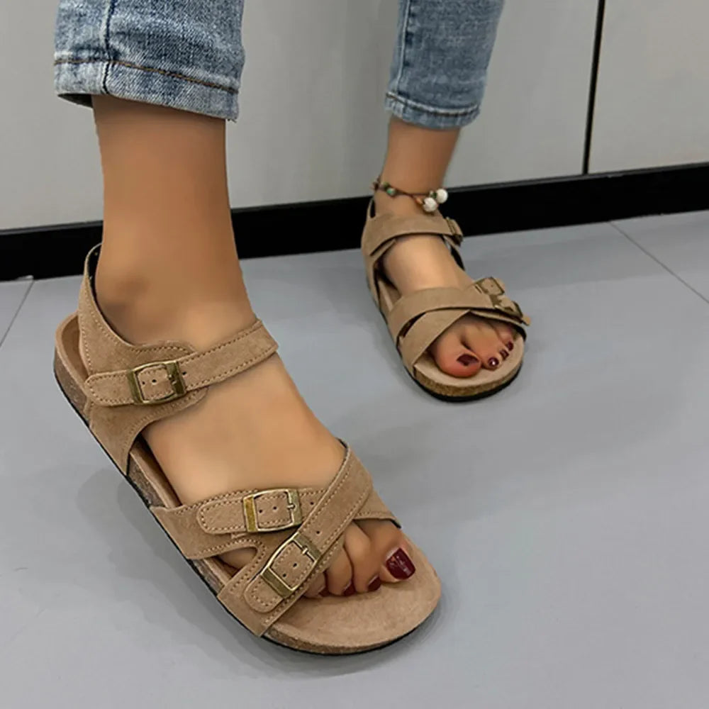 Khaki suede crossover buckle cork sandals with adjustable straps.