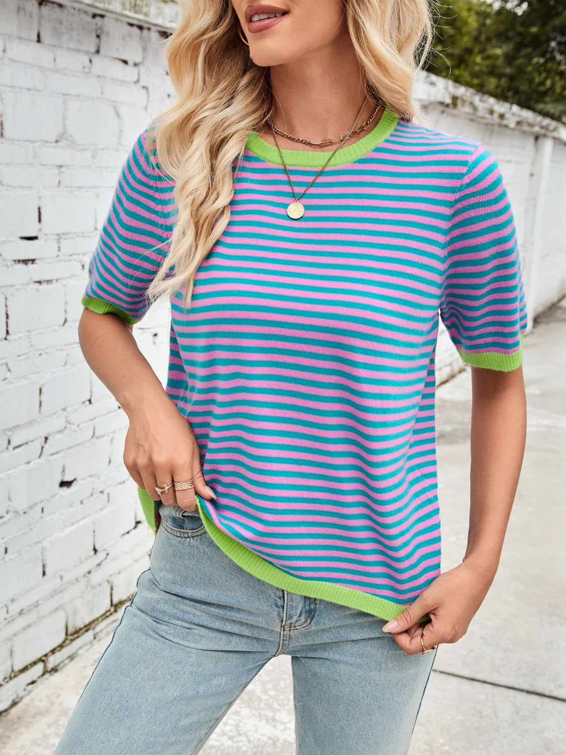 Striped knit tee with pink and teal horizontal stripes and lime green trim.