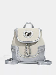 Charming mini heart flap backpack in cream and silver with chain detail.