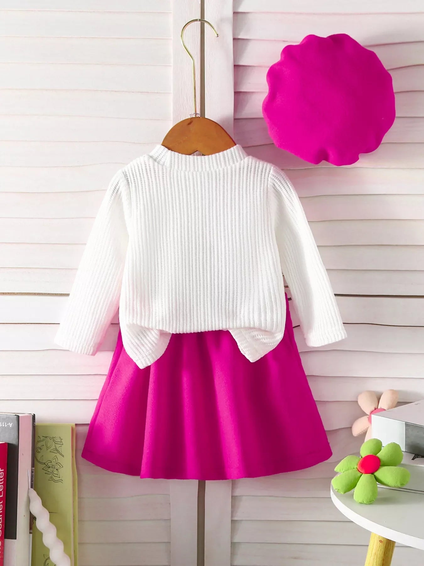 Baby knit top and skirt set in white and hot pink with floral applique detail.