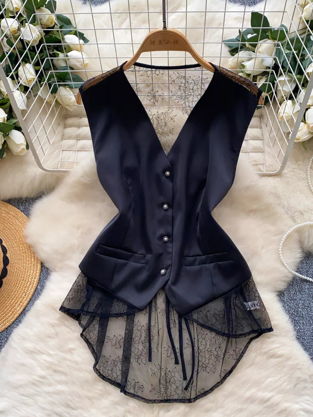 Black button-down vest coat with lace embellishments and a high-low hem.