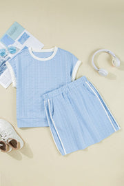 Light blue cable knit loungewear set with white trim and striped shorts.