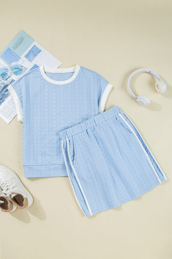 Light blue cable knit loungewear set with white trim and striped shorts.