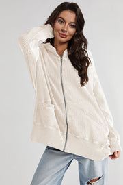 Beige waffle knit zip-through hoodie with front pockets and a relaxed fit.