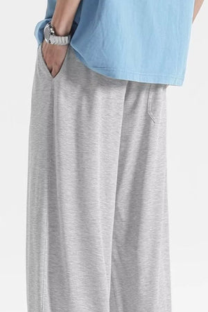 Light gray sweatpants with pockets and drawstring detail.