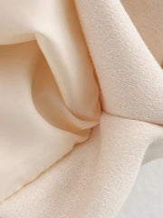 Oversized zip-up jacket in off-white with a soft knit texture and smooth lining.