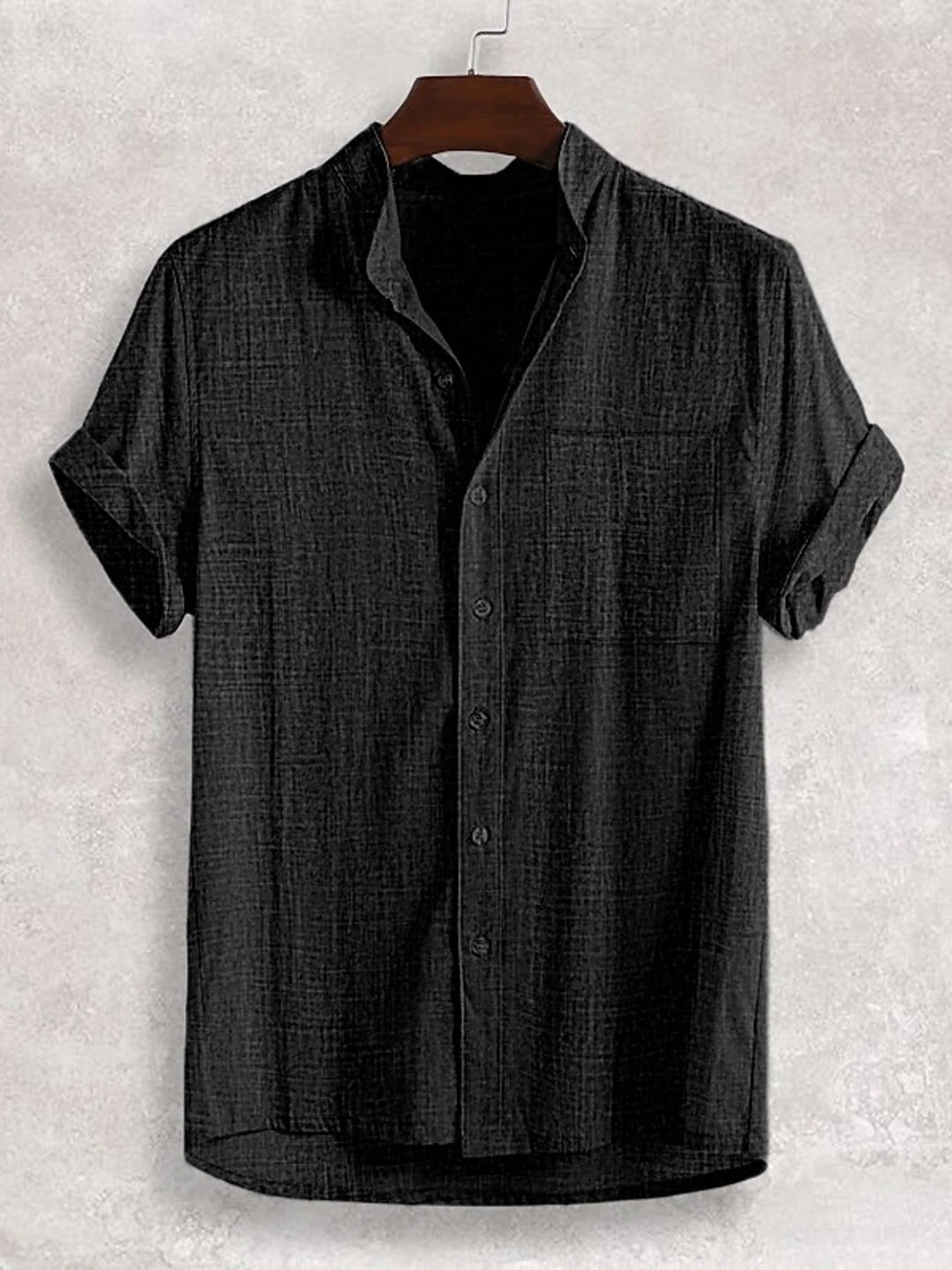 Black textured band collar casual shirt with cuffed short sleeves and a chest pocket.