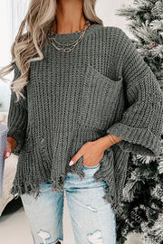 Distressed knit sweater in dark gray with a chest pocket and frayed hem.