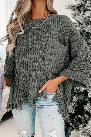Distressed knit sweater in dark gray with a chest pocket and frayed hem.