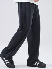 Black relaxed fit joggers with drawstring and side stripe detail.