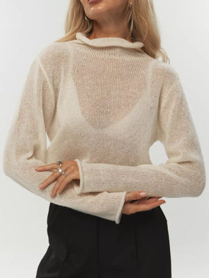 Sheer mock neck knit sweater in apricot with a ruffled neckline and long sleeves.