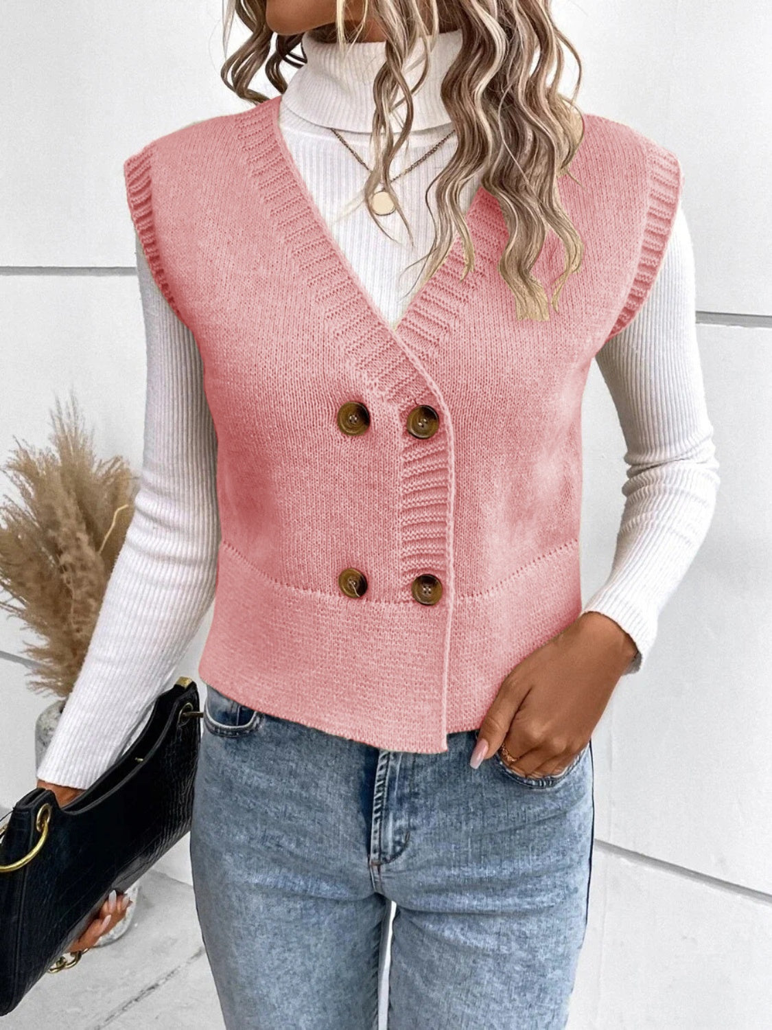 Dusty pink double-breasted knit vest with ribbed trim and buttons.