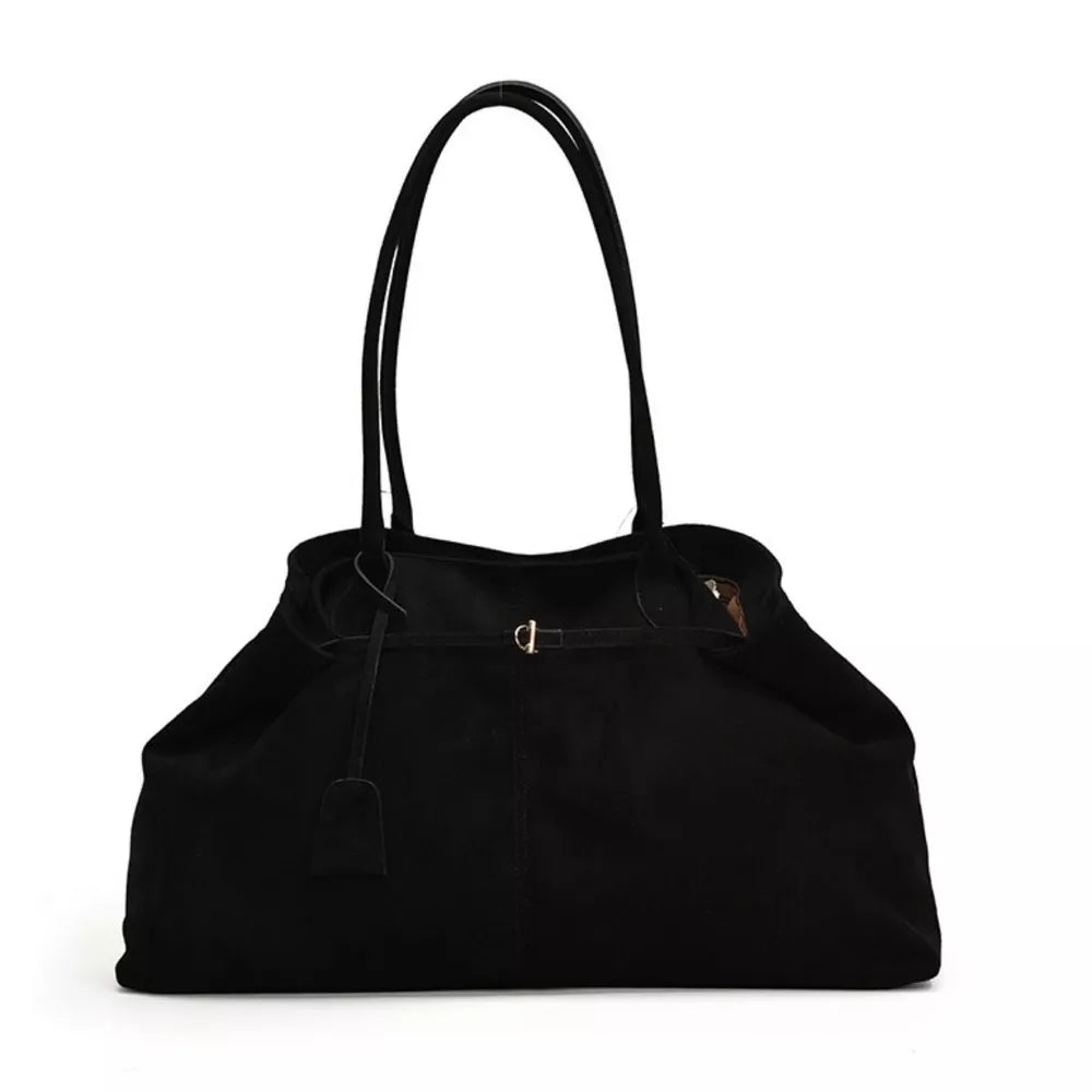 Black suede slouchy shoulder bag with drawstring and buckle detail.