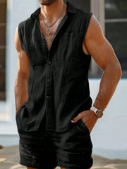 Black linen blend sleeveless button-up shirt and shorts ensemble worn by a man.