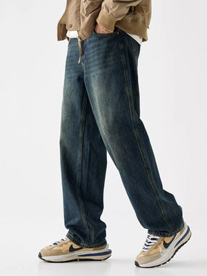 Loose fit blue denim jeans with vintage wash and visible stitching detail.