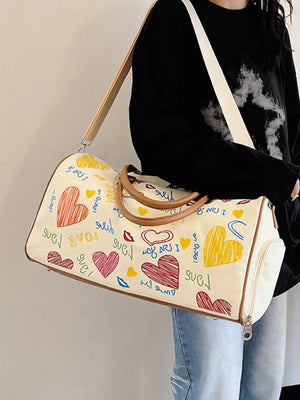 Vibrant canvas duffel bag with colorful heart print and adjustable strap