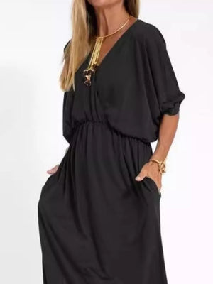 Black V-neck maxi dress with dolman sleeves, elastic waist, and side pockets.